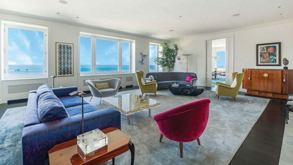 A living room with couches, chairs and tables.